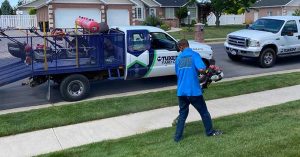 Tuxedo Yard Care employee edging a lawn in Kaysville, Utah